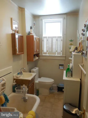 a bathroom with a sink toilet and a mirror