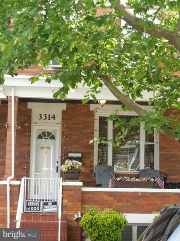 front view of a house with a tree