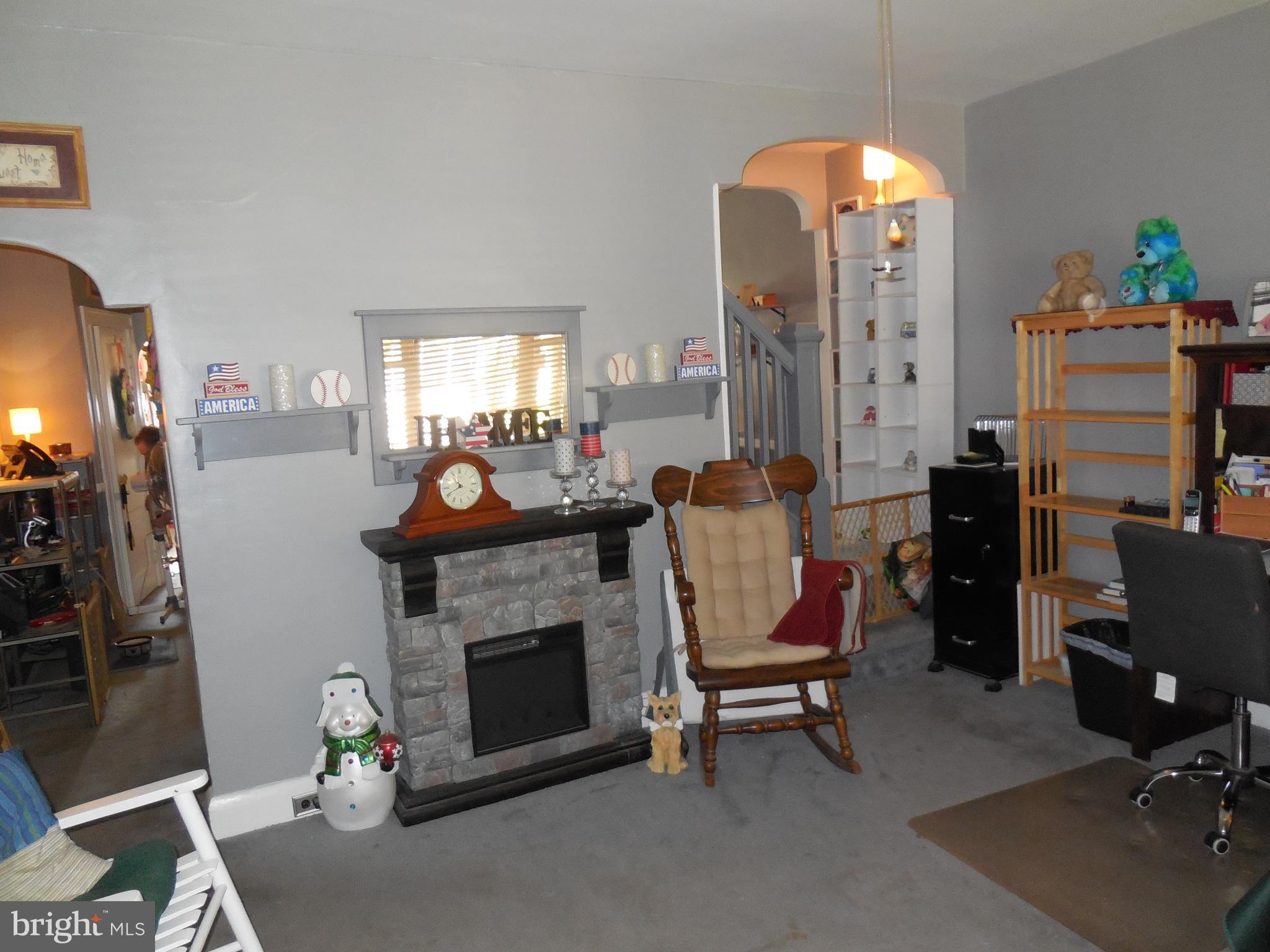 3314 Kenyon Avenue Baltimore, MD 21213 - Photo 5 of 21 a living room with furniture and a fireplace