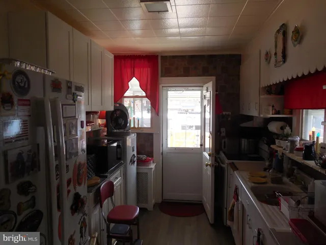 a kitchen with refrigerator a stove a washer dryer and a refrigerator