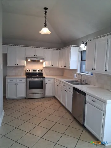 a kitchen with a sink cabinets and window