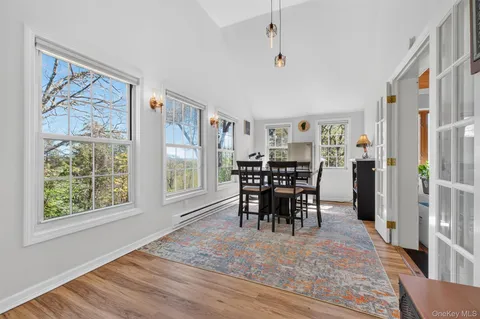 a view of a dining room with furniture window and wooden floor