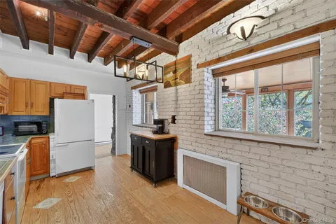 a view of a refrigerator in kitchen and wooden floor