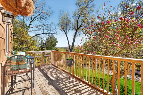 a view of balcony with wooden floor and fence
