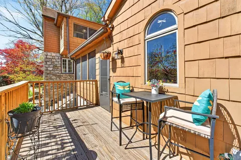 a view of a patio with table and chairs and wooden floor