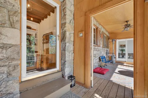 a view of a balcony with wooden floor and furniture