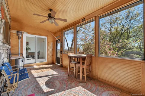 a dining room with wooden floor and a rug
