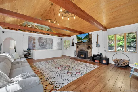 a living room with furniture a fireplace and window