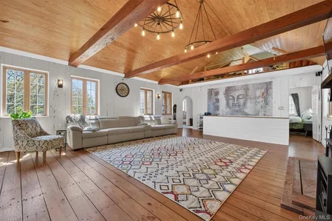 a living room with couch and wooden floor