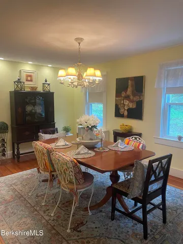 a dining room with furniture and chandelier kitchen view