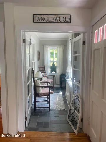 a view of a livingroom with furniture and hardwood floor