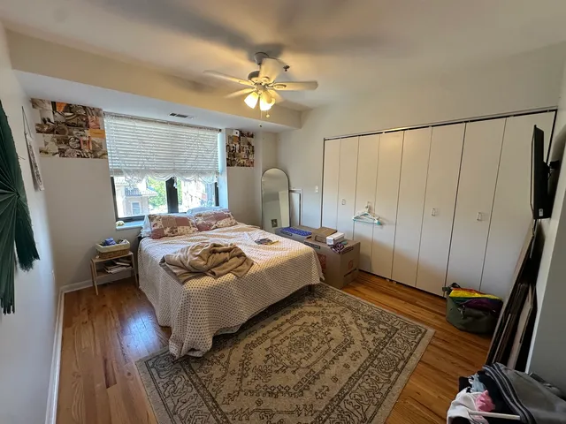 a bedroom with a bed and wooden floor