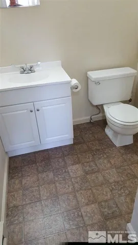 a bathroom with a sink toilet and mirror