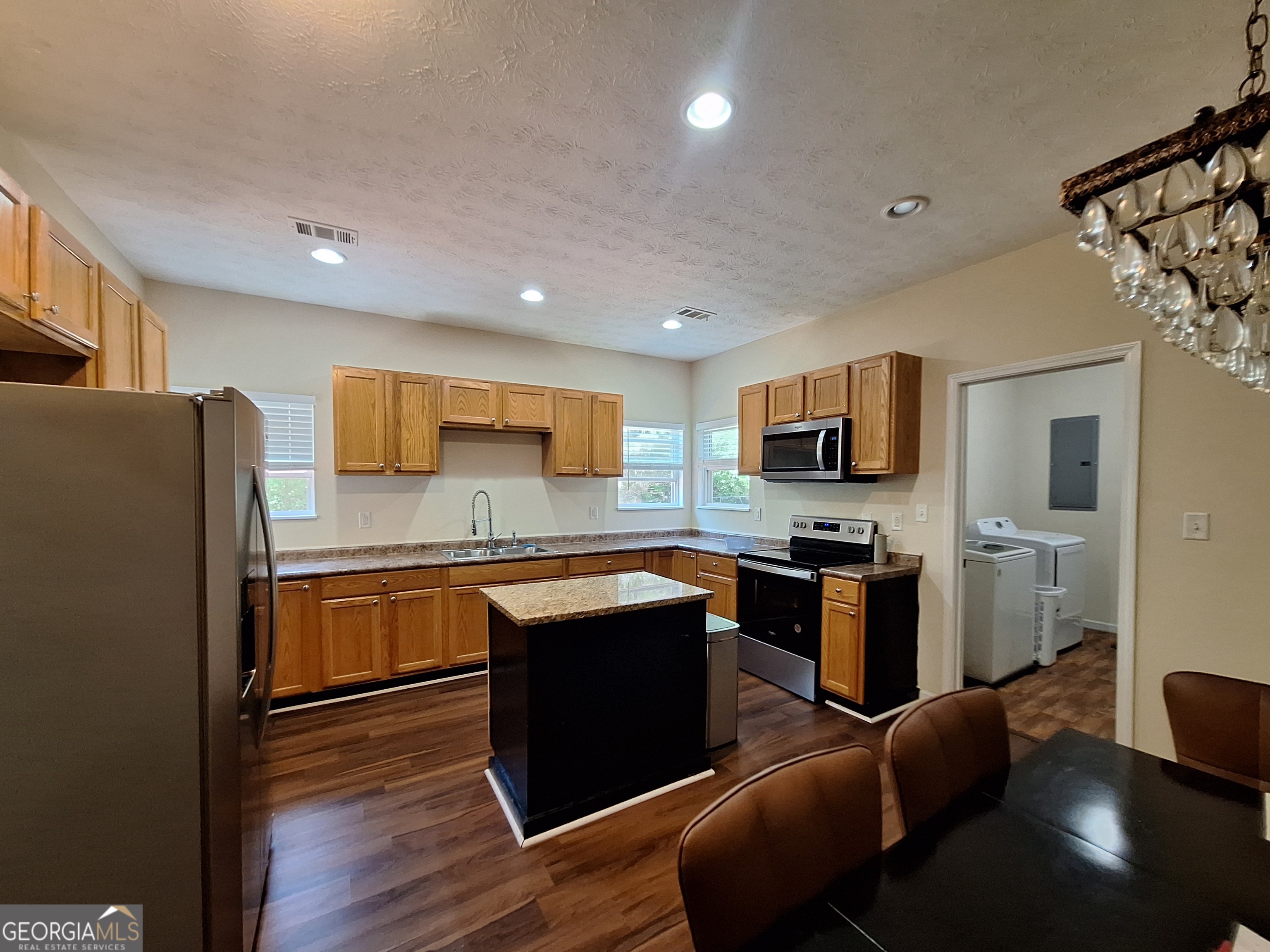 806 Springfield Drive Lafayette, AL 36862 - Photo 6 of 19 a kitchen with stainless steel appliances granite countertop a refrigerator a stove top oven a sink dishwasher and wooden cabinets with wooden floor