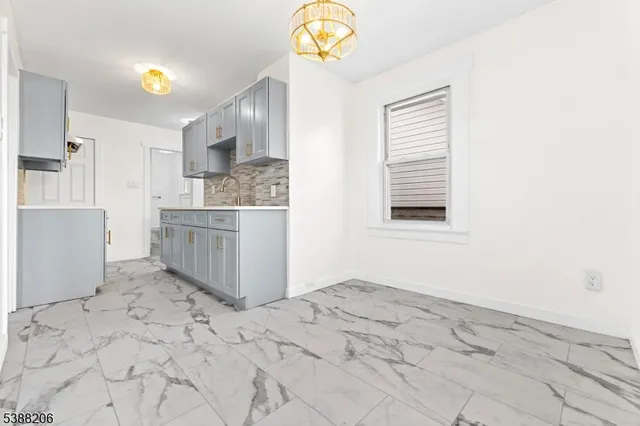 a view of kitchen and hall with wooden floor