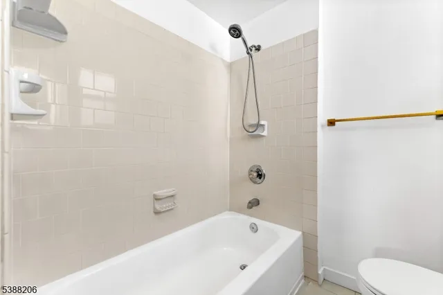a white bath tub sitting next to a white toilet and sink
