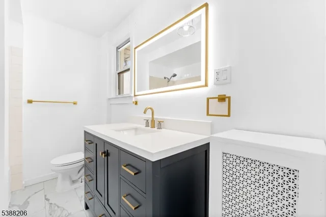 a bathroom with a sink a toilet and mirror