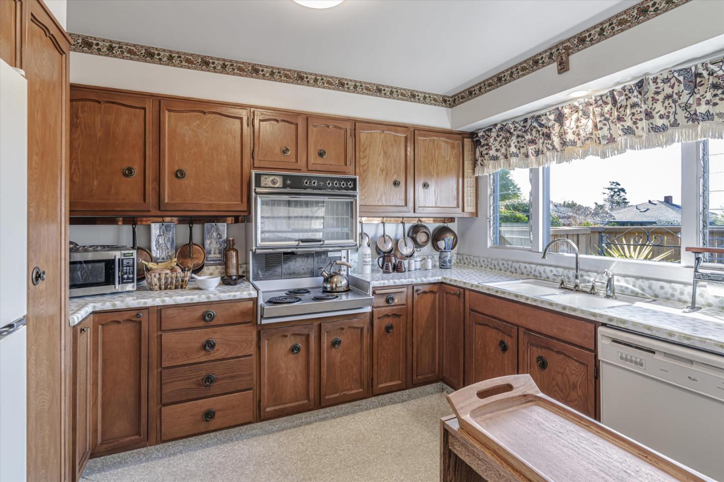 74 Del Mesa Carmel Carmel, CA 93923 - Photo 6 of 20 a kitchen with a sink window and cabinets
