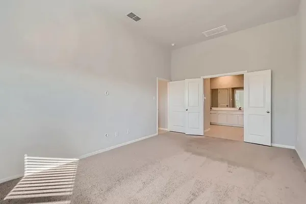 a view of a big room with wooden cabinet and windows