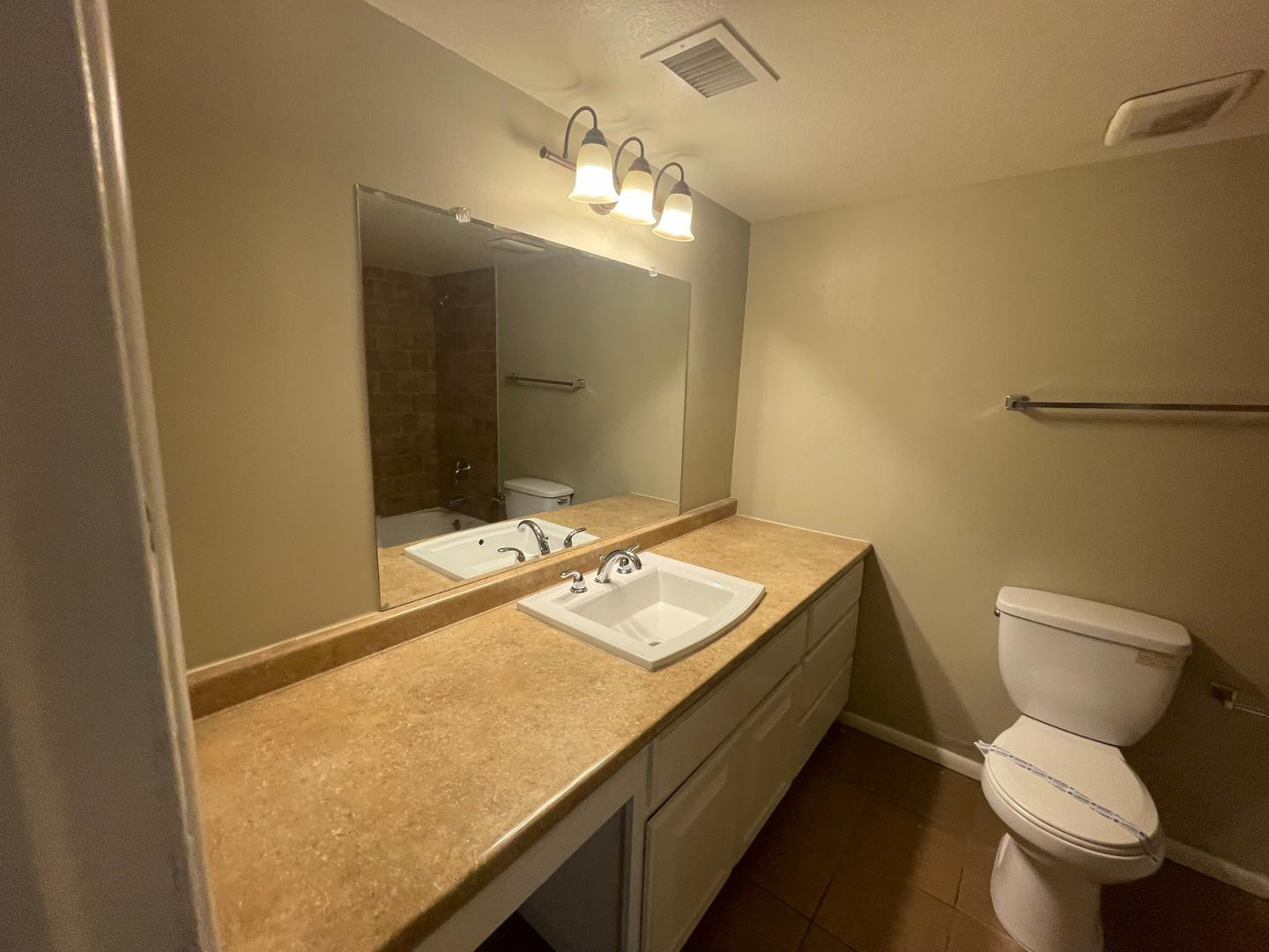 10902 West Montecito Avenue Phoenix, AZ 85037 - Photo 14 of 22 a bathroom with a granite countertop sink and a mirror