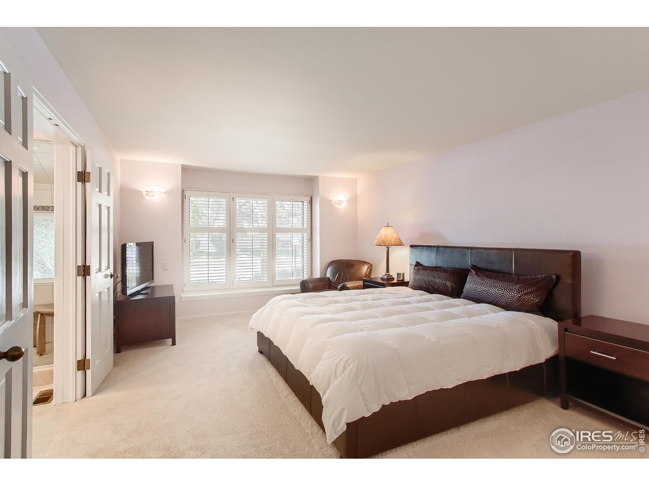 7235 Four Rivers Road Boulder, CO 80301 - Photo 18 of 38 a bedroom with a bed a couch and large window