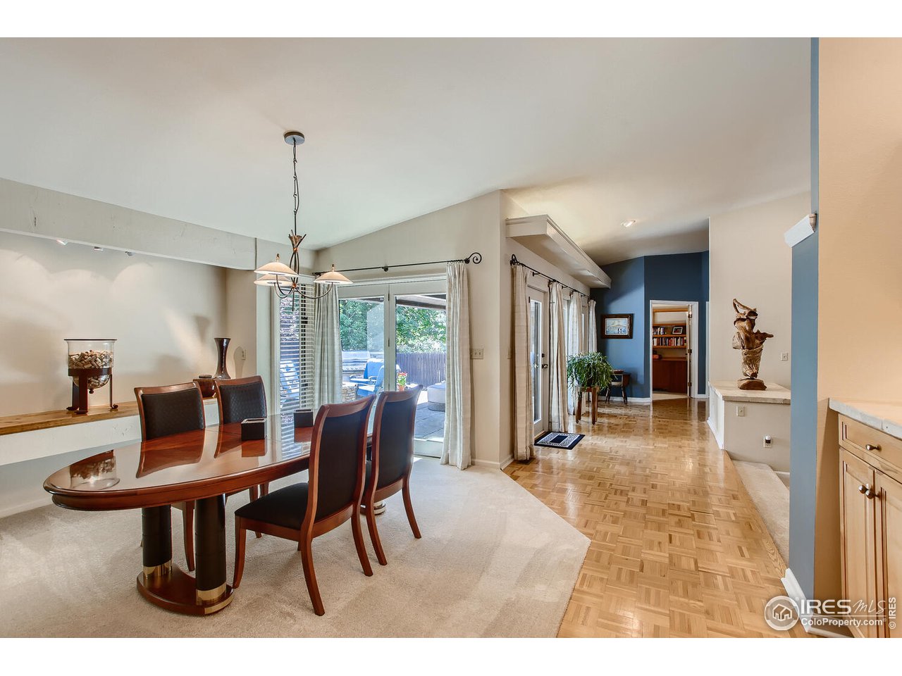 7235 Four Rivers Road Boulder, CO 80301 - Photo 8 of 38 a dining room with furniture a chandelier and wooden floor