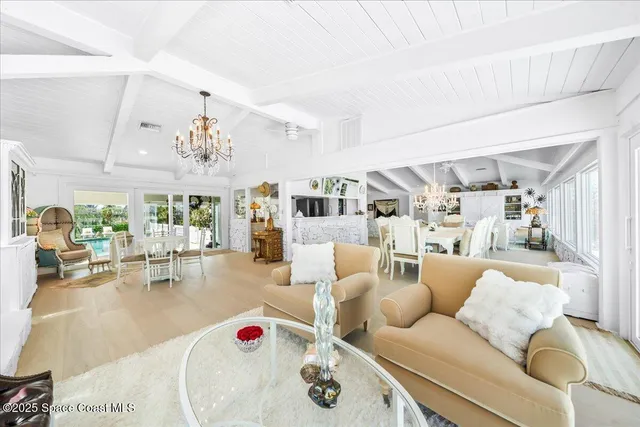 a living room with lots of furniture and a large window