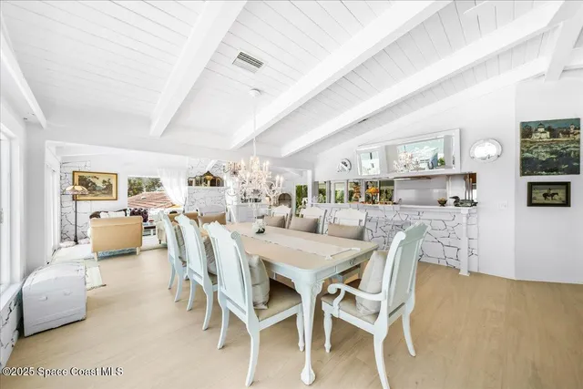 a bedroom with a bed and dresser with mirror