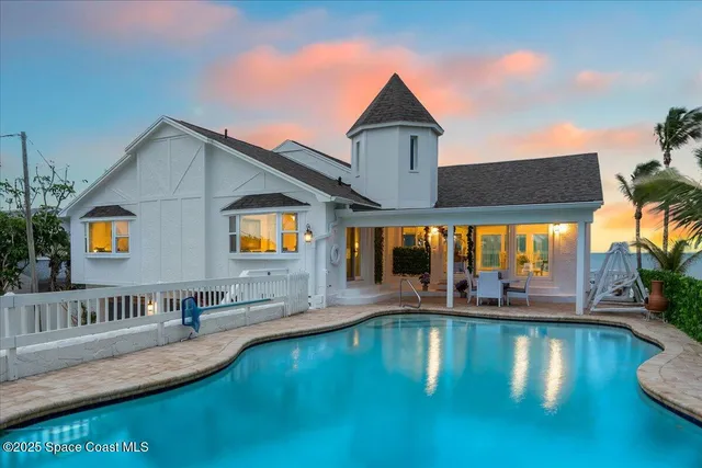 a living room with furniture a fireplace and a floor to ceiling window
