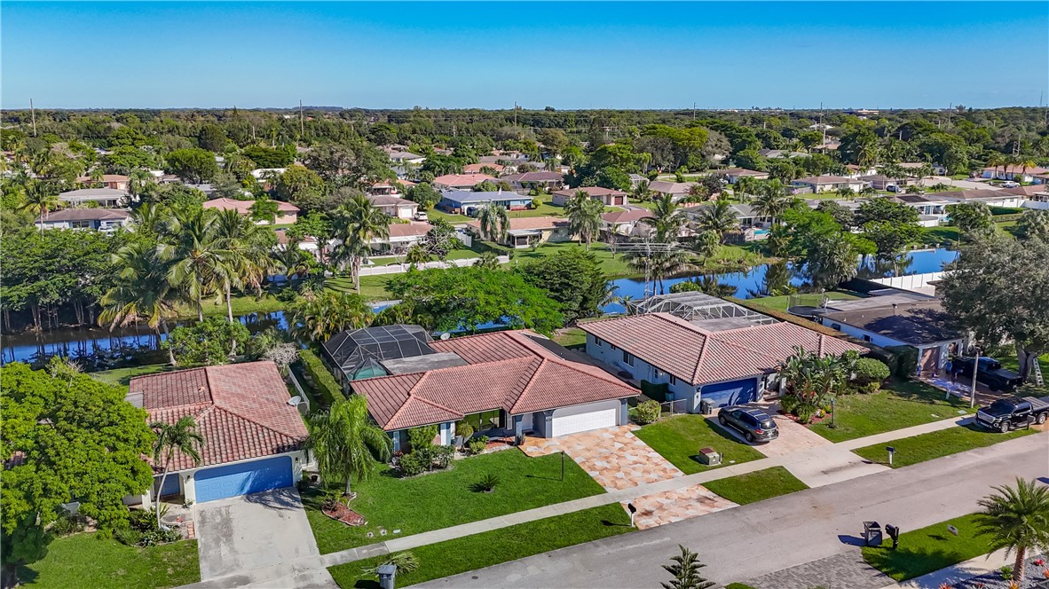 4667 Baldric Street Boca Raton, FL 33428 - Photo 1 of 32 an aerial view of residential houses with outdoor space and ocean view