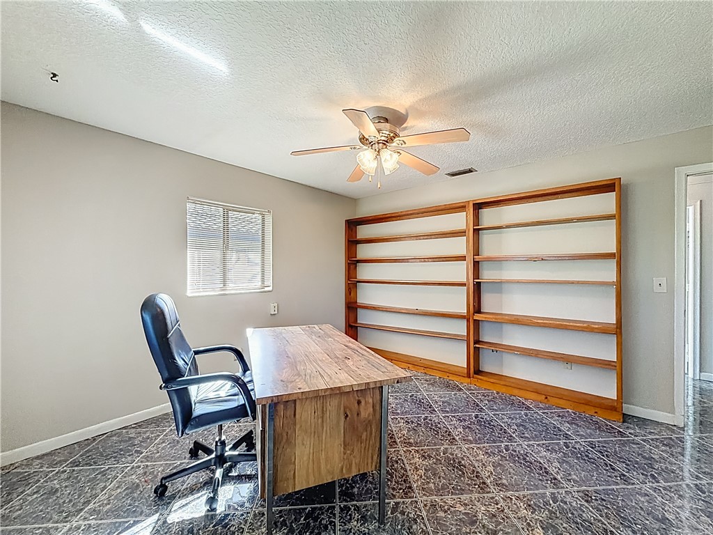 4667 Baldric Street Boca Raton, FL 33428 - Photo 23 of 32 a view of a workspace with furniture and a window