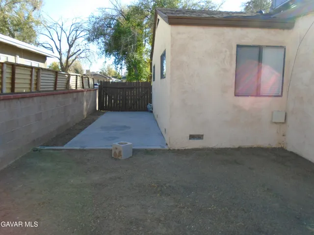 a view of backyard with wooden fence
