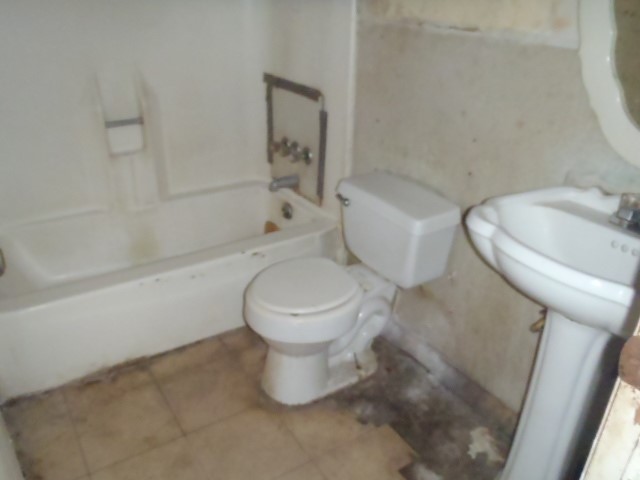 652 Fir Lane Lockhart, TX 78644 - Photo 23 of 26 a white toilet sitting next to a bath tub