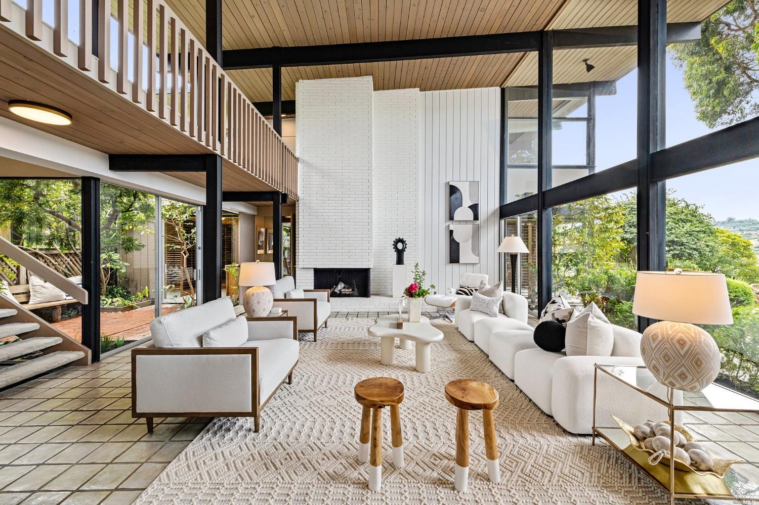 a living room with patio furniture and a large window