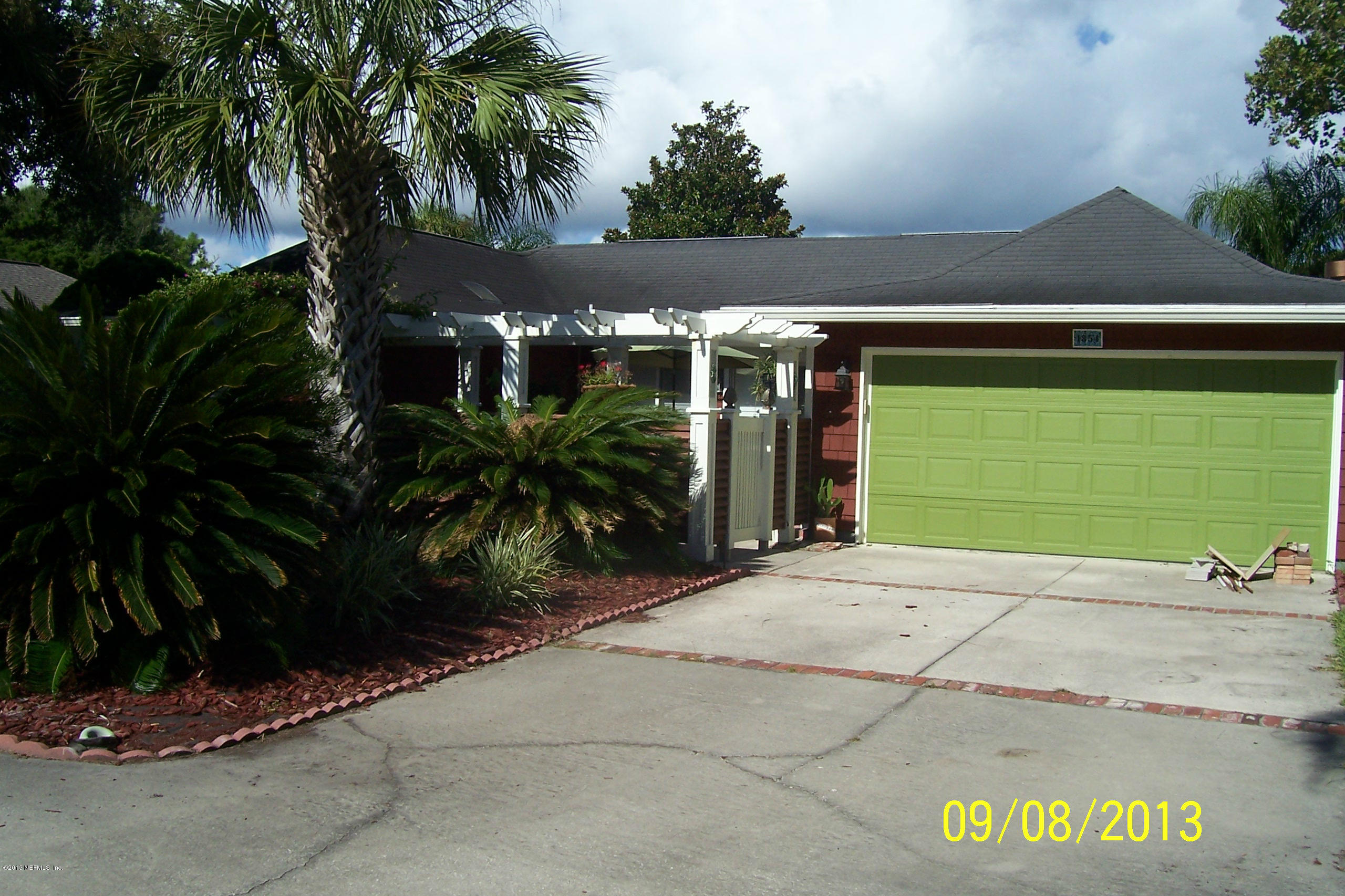 1854 Seminole Road Atlantic Beach, FL 32233 - Photo 17 of 33 a backyard of a house with potted plants and palm trees
