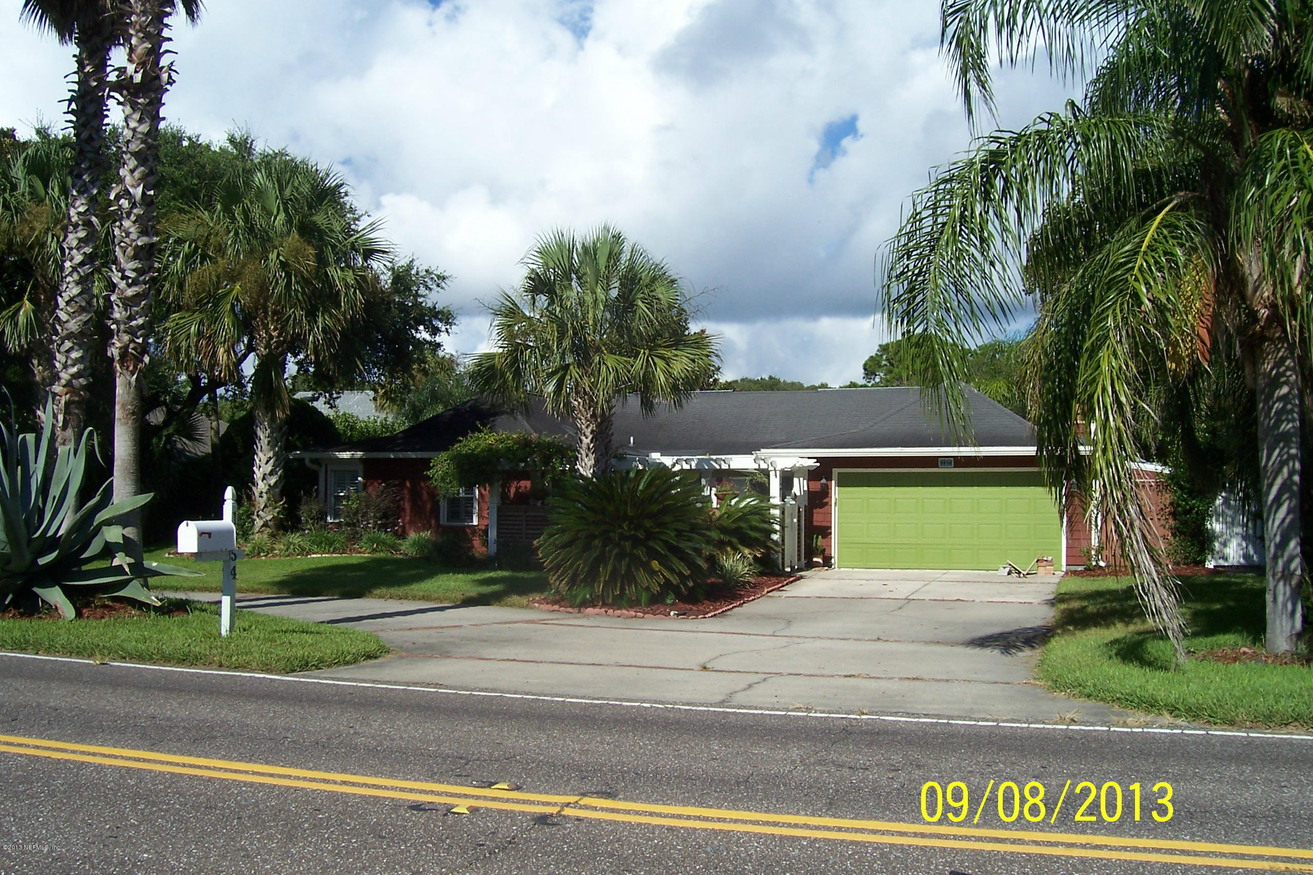 1854 Seminole Road Atlantic Beach, FL 32233 - Photo 18 of 33 a view of a house with a yard and palm trees