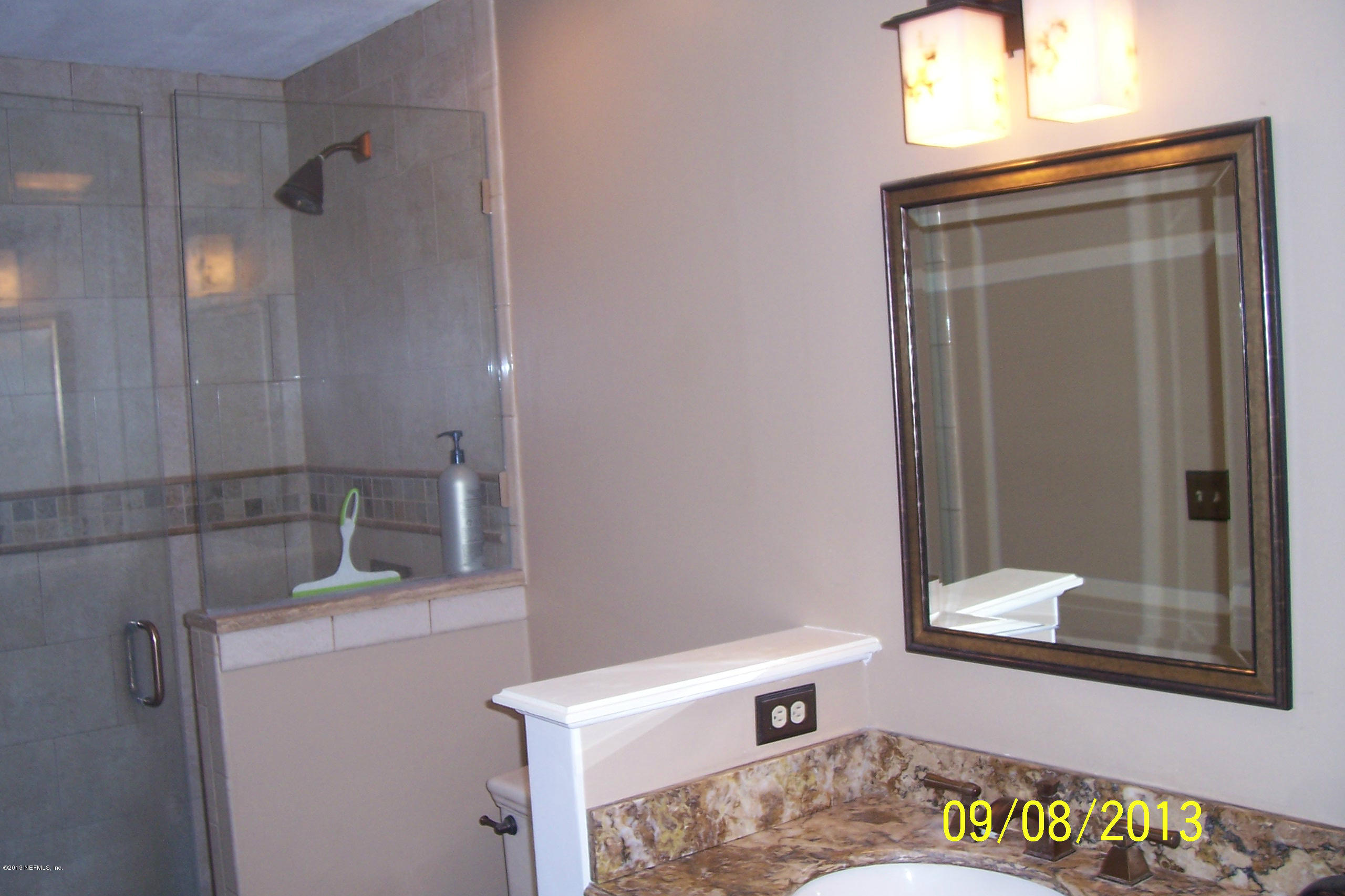 1854 Seminole Road Atlantic Beach, FL 32233 - Photo 10 of 33 a bathroom with a sink a vanity and a mirror