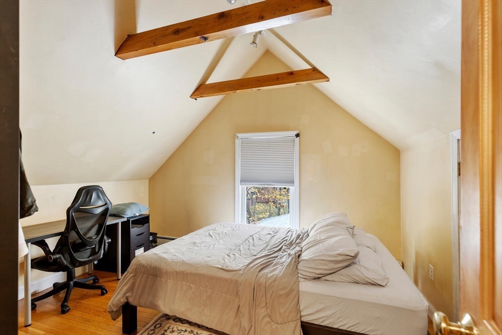 46 Bartlett Street Malden, MA 02148 - Photo 18 of 32 a bedroom with a bed and a workspace