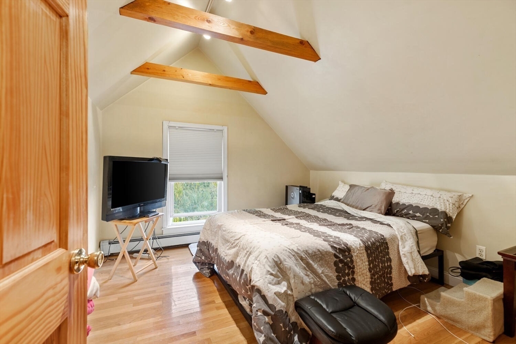 46 Bartlett Street Malden, MA 02148 - Photo 19 of 32 a bedroom with a bed and a flat screen tv