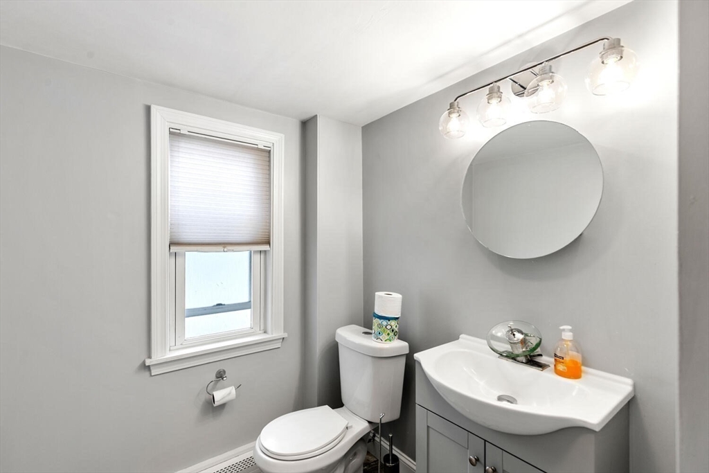 46 Bartlett Street Malden, MA 02148 - Photo 20 of 32 a bathroom with a sink mirror and toilet