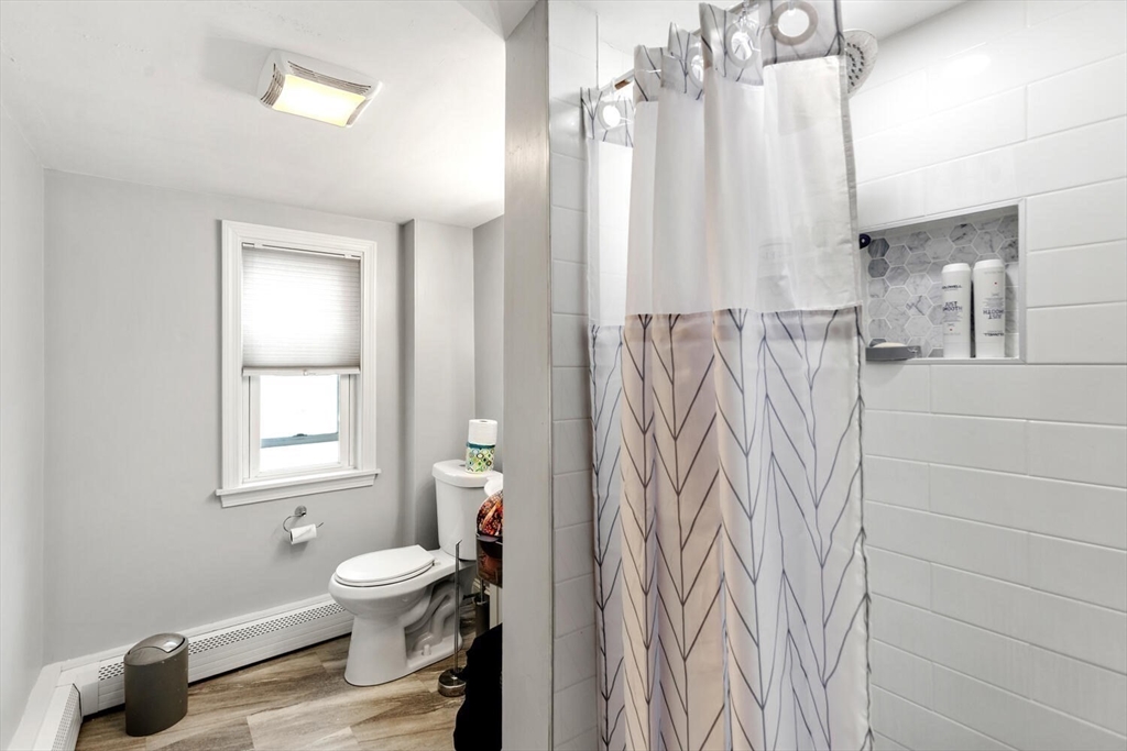 46 Bartlett Street Malden, MA 02148 - Photo 21 of 32 a bathroom with a toilet a sink and a window