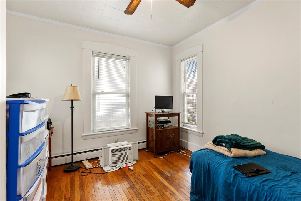 46 Bartlett Street Malden, MA 02148 - Photo 25 of 32 a bedroom with furniture and a window
