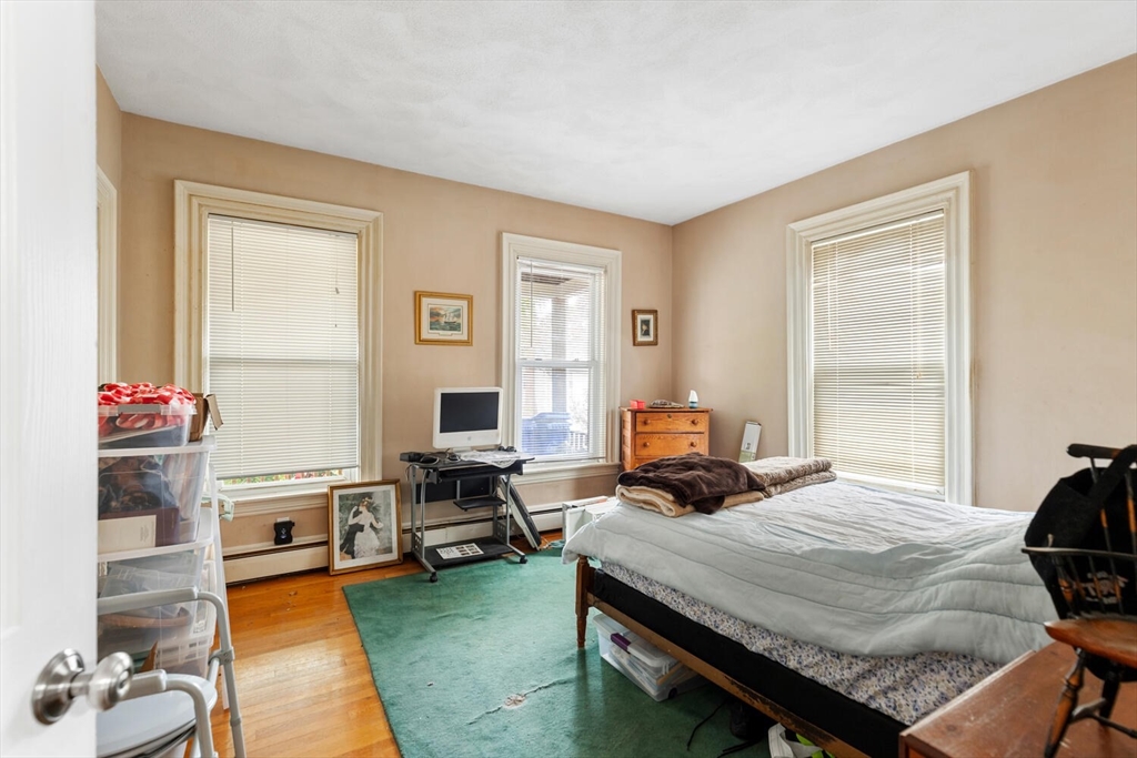 46 Bartlett Street Malden, MA 02148 - Photo 26 of 32 a bedroom with a bed and wooden floor