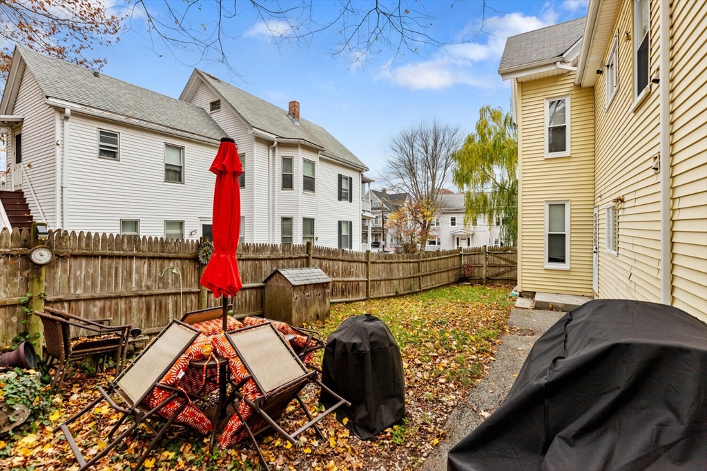 46 Bartlett Street Malden, MA 02148 - Photo 27 of 32 a view of a balcony with chairs and wooden floor