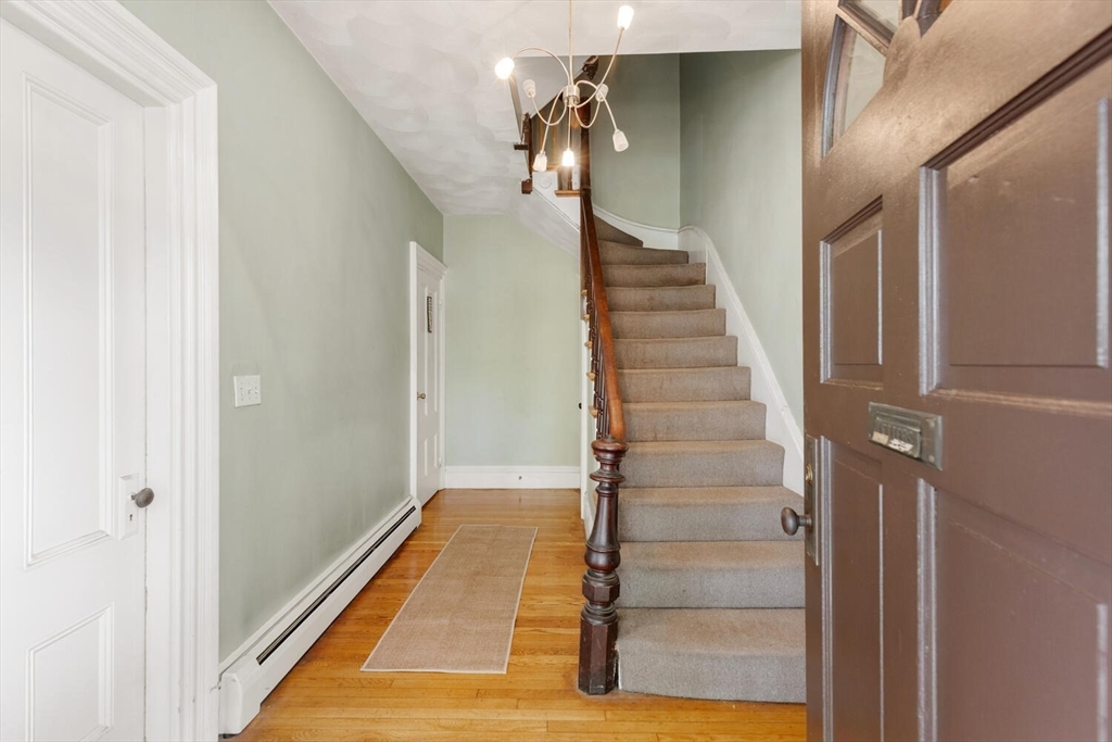46 Bartlett Street Malden, MA 02148 - Photo 4 of 32 a view of a hallway with wooden floor and staircase