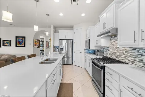 a kitchen with stainless steel appliances granite countertop a sink and cabinets
