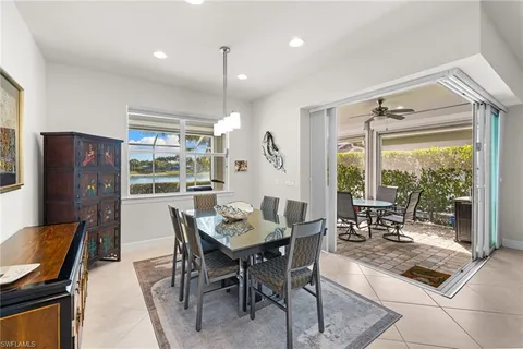 a dining room with furniture a chandelier and wooden floor
