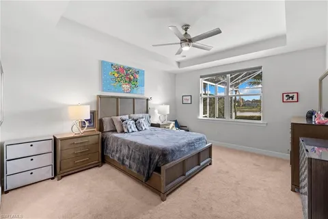 a bedroom with a bed dresser and window