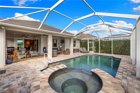 a view of a patio with swimming pool table and chairs