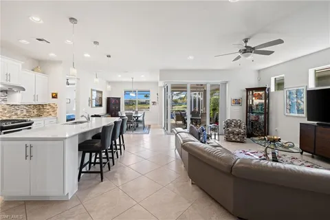 a living room with furniture and kitchen view